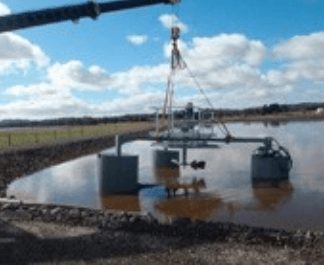 crane lifting aerator into place